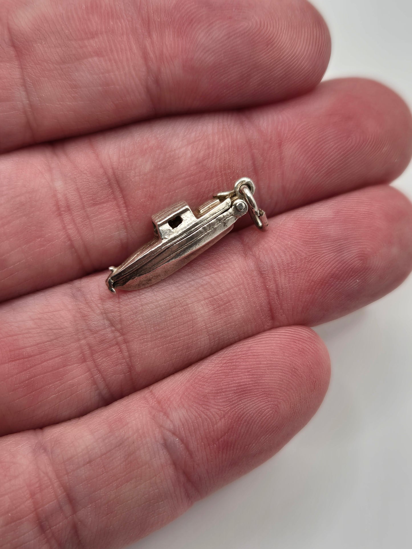 Silver man in boat charm
