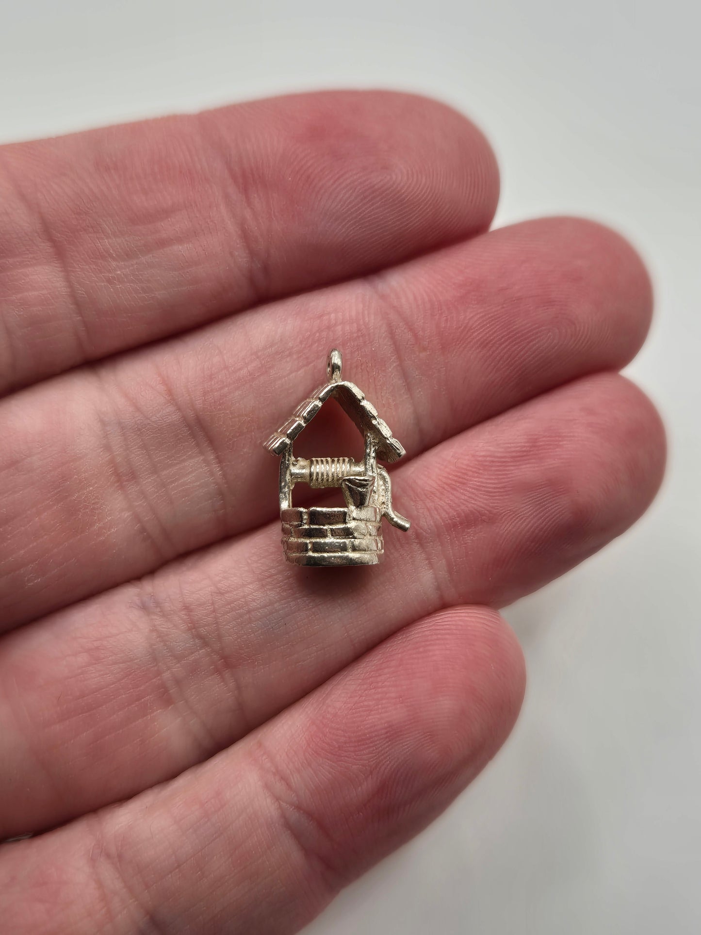 Silver wishing well charm