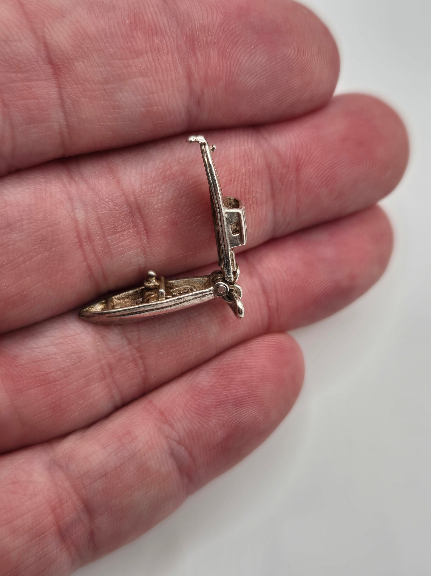 Silver man in boat charm