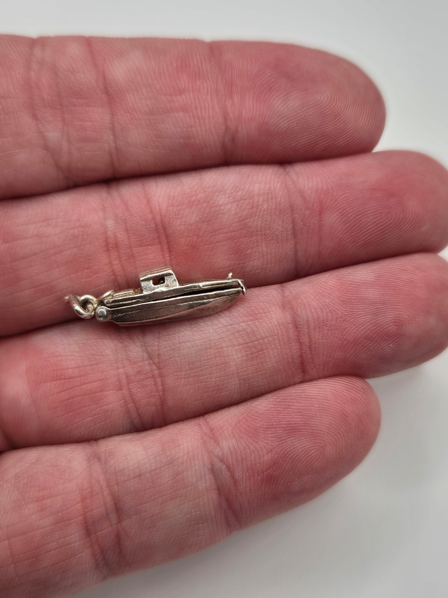 Silver man in boat charm