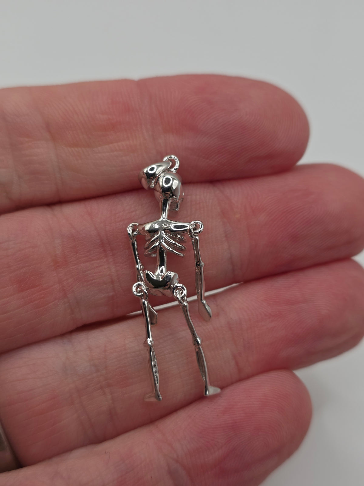 Silver articulated skeleton pendant