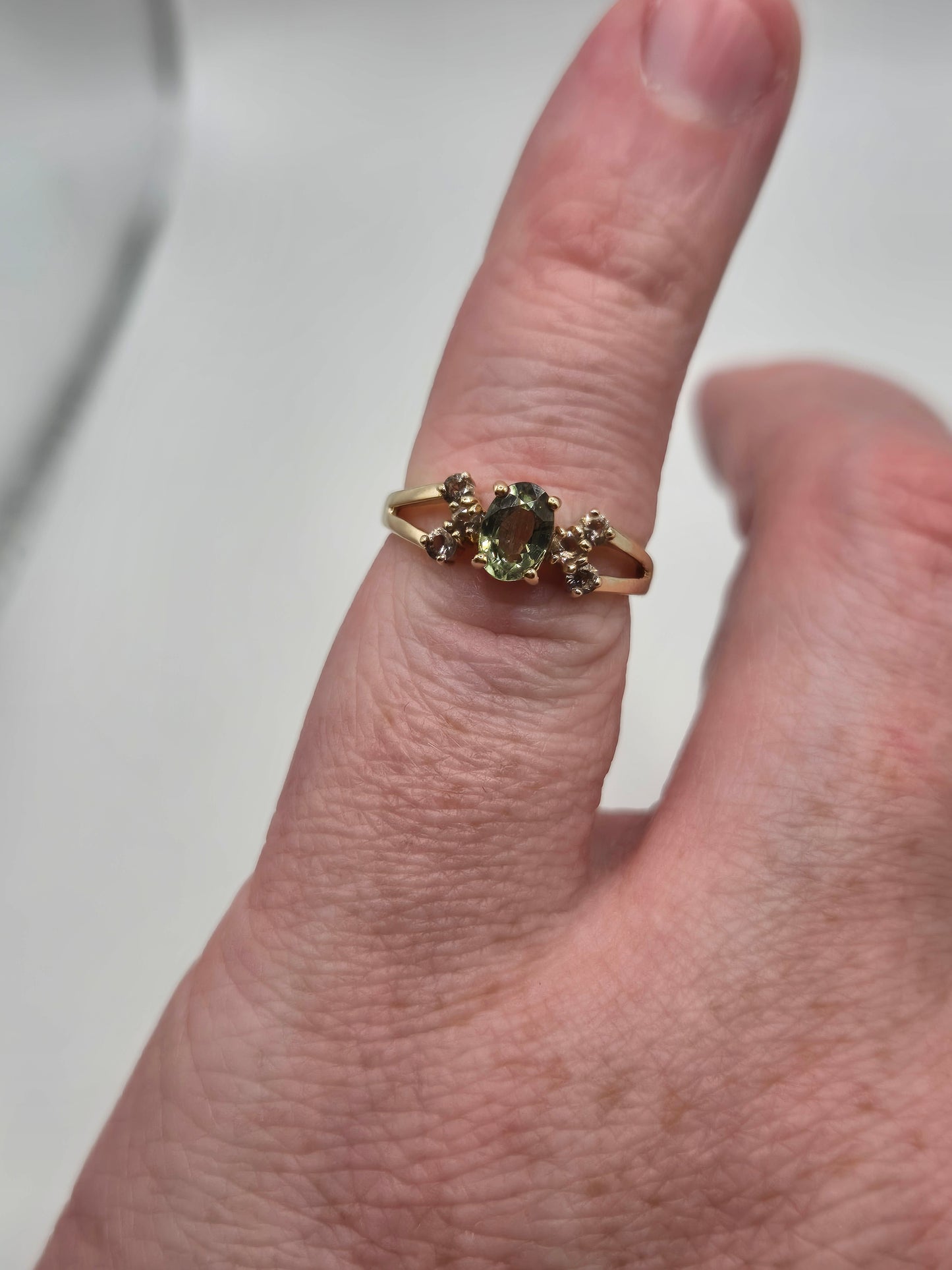 9ct gold green sapphire and white zircon ring