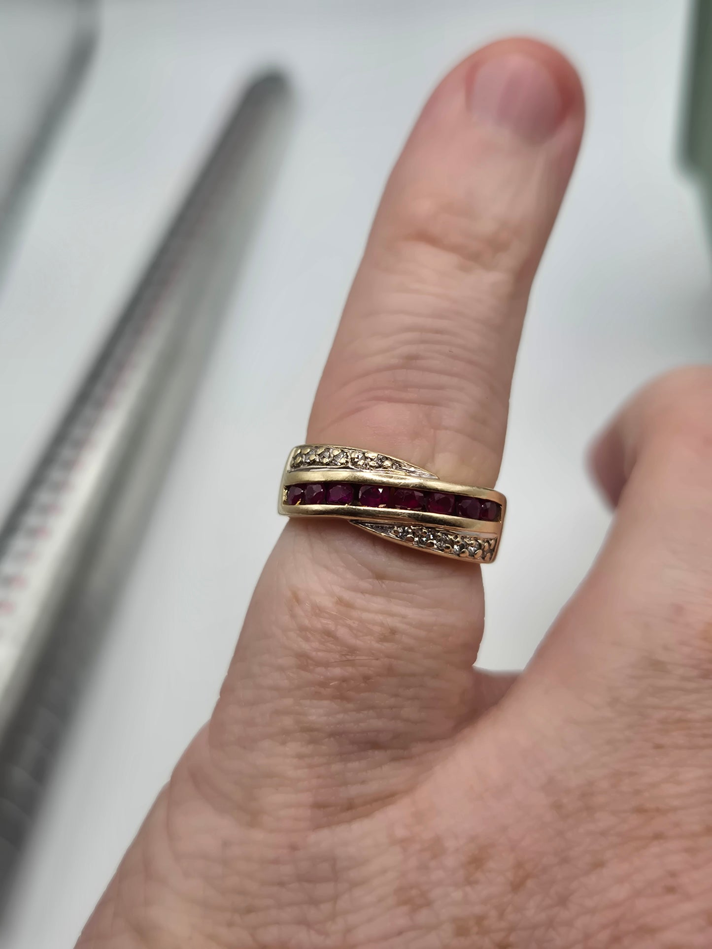 Heavy 9ct gold ruby and diamond cross over ring