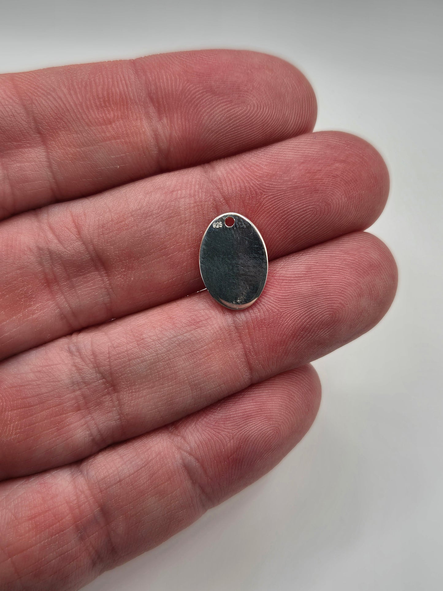Silver oval disc