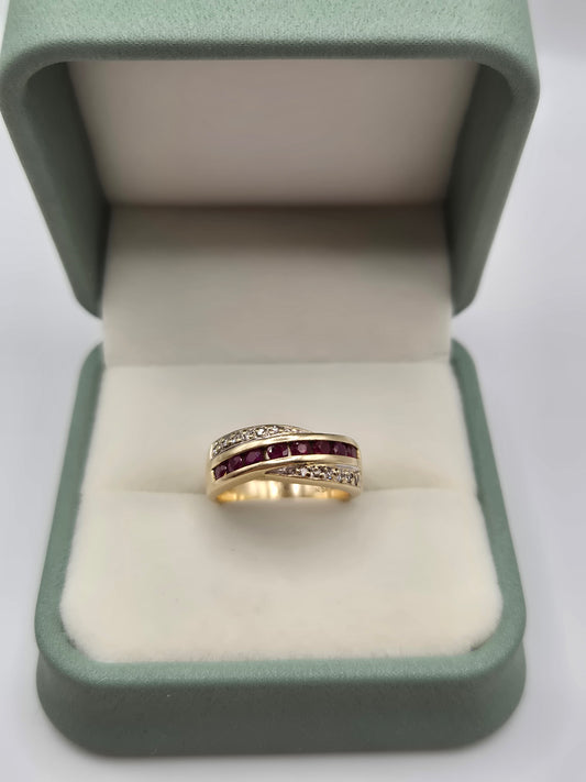 Heavy 9ct gold ruby and diamond cross over  ring